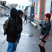 Sixty plus redhead entices a pair of guys on the street in slutwear